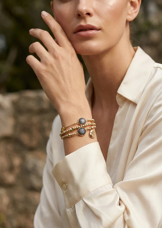 Gold triple layer stretched bracelet with grey bead design