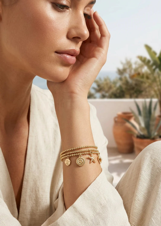 Gold triple layered stretch bracelet with sea charms