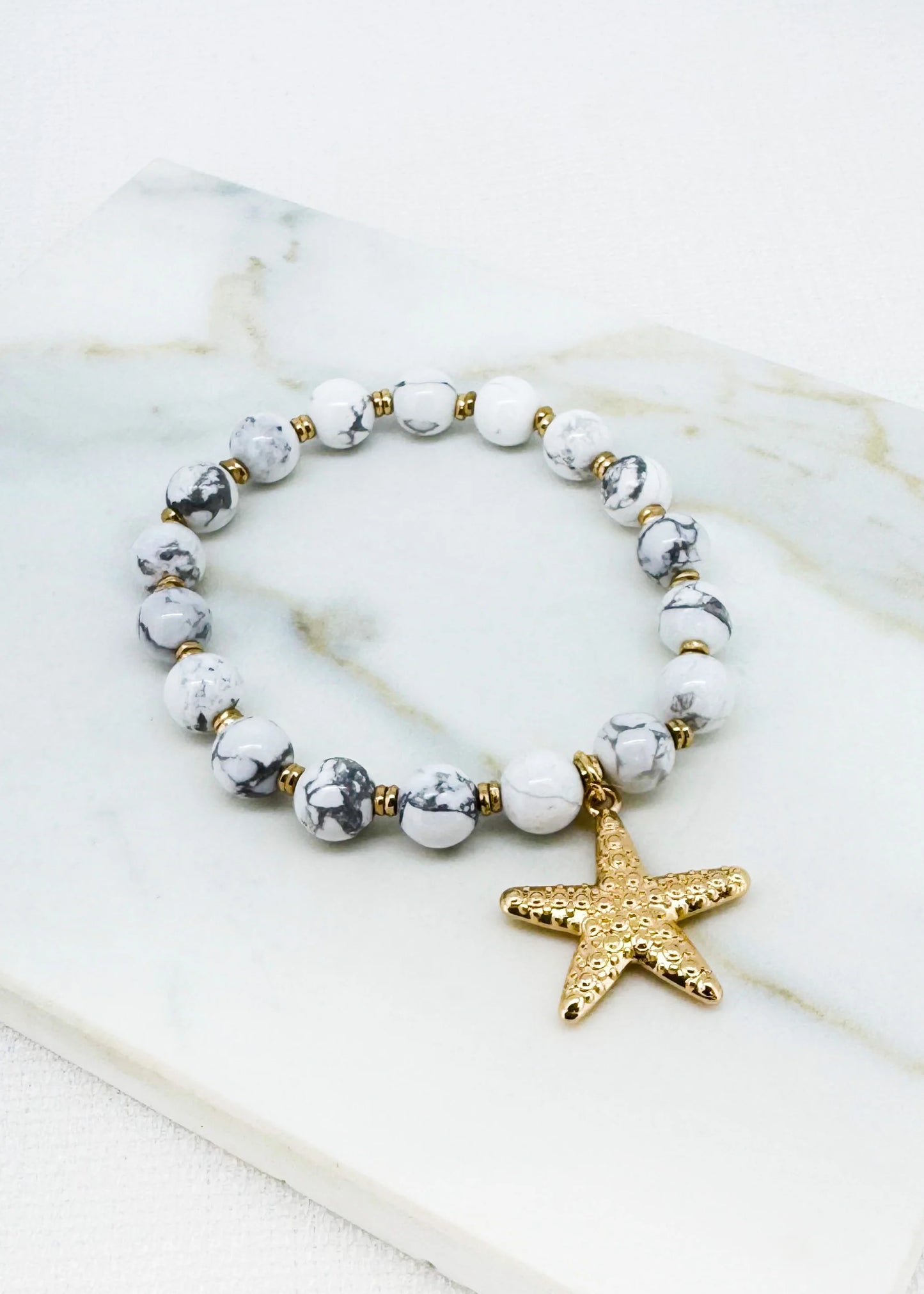 White bead stretch bracelet with gold starfish charm