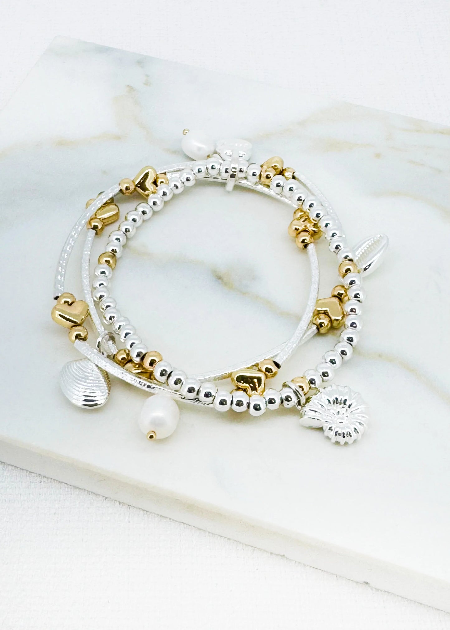 Silver triple layer bead and bar elasticated bracelet with pearl and shell charms